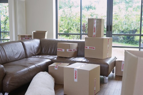 Careful packing of household items using boxes and wrapping materials in Bromley