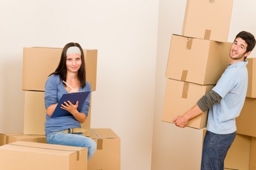 Trained movers handling boxes carefully during a Bromley relocation